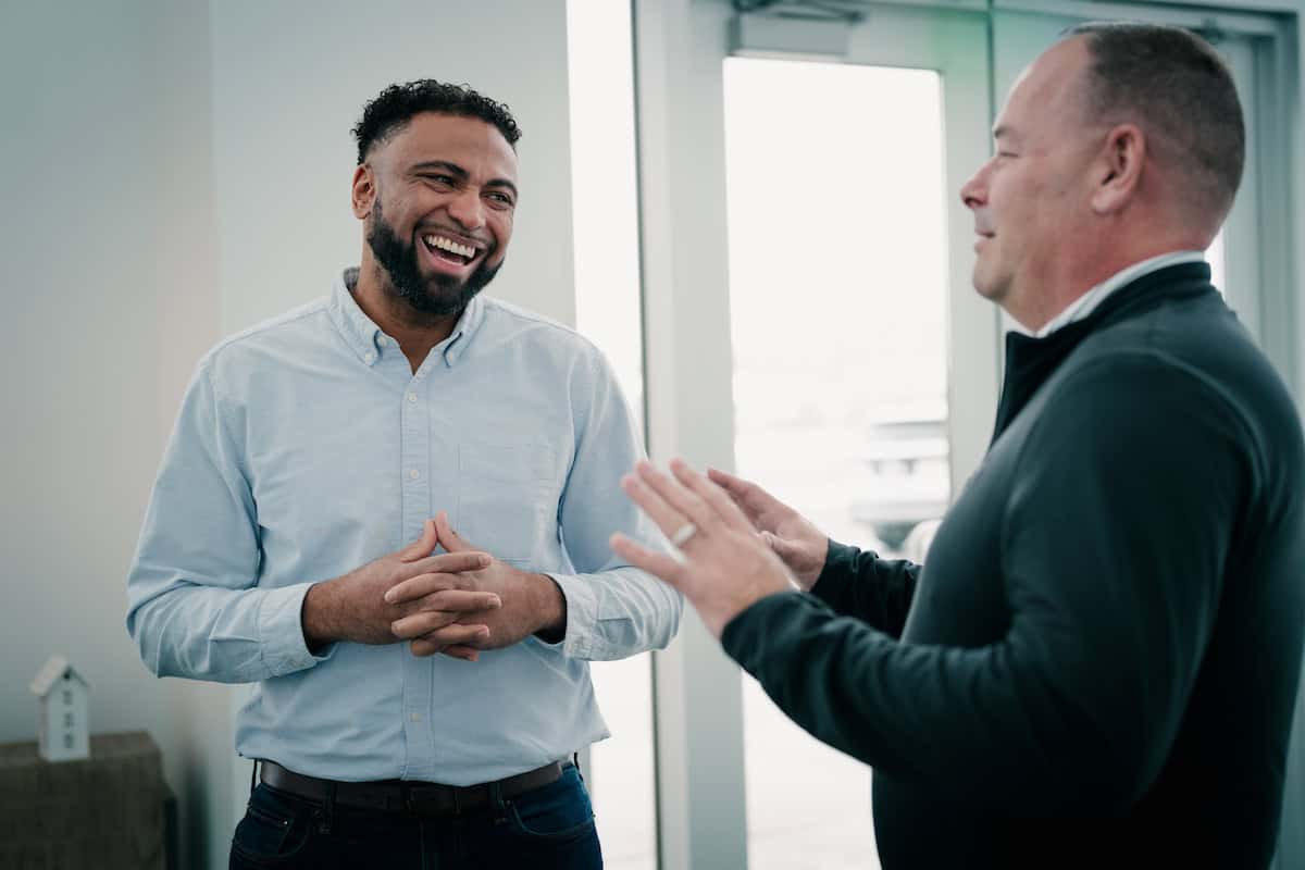 Two men engaged in conversation in an office