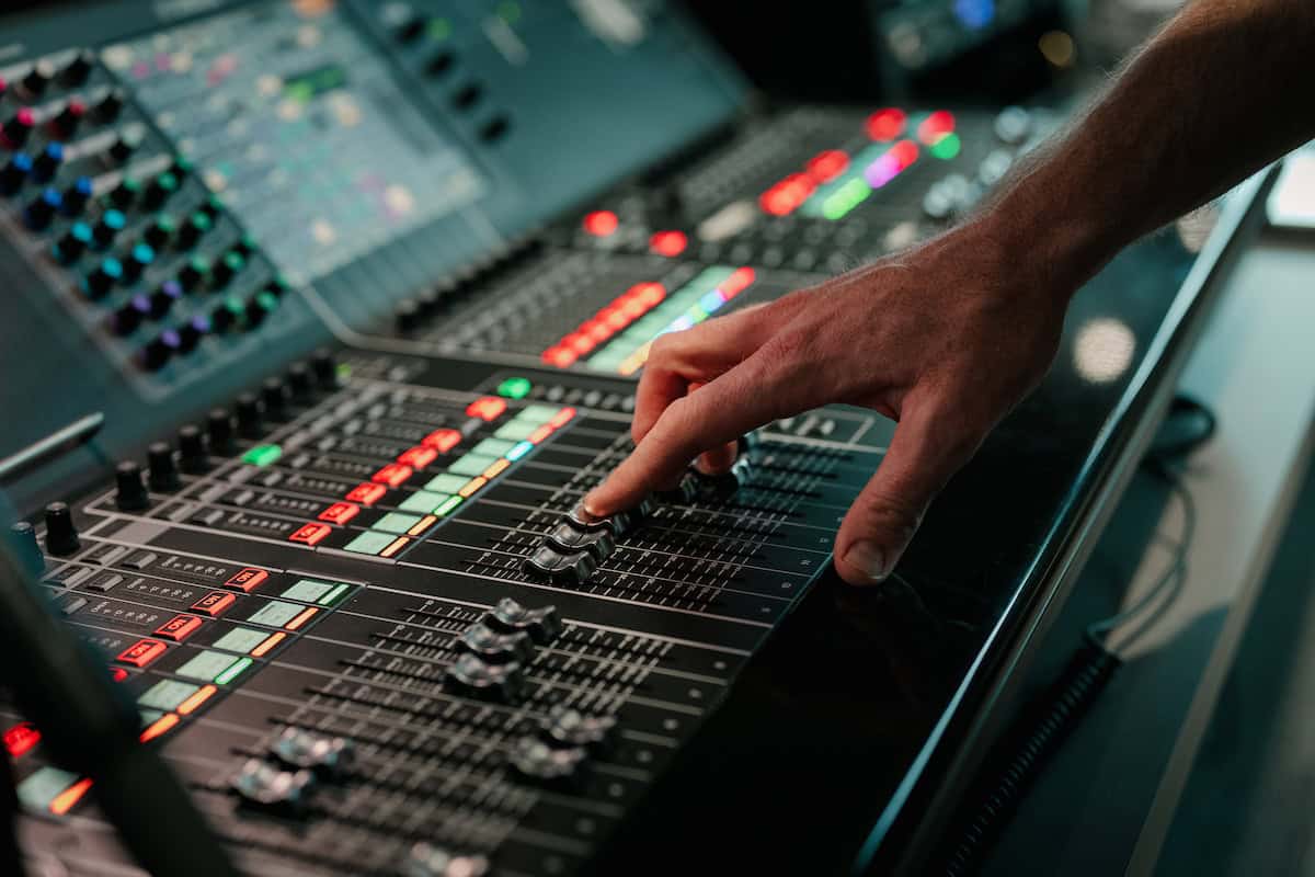 A professional audio mixing board with colorful buttons and sliders