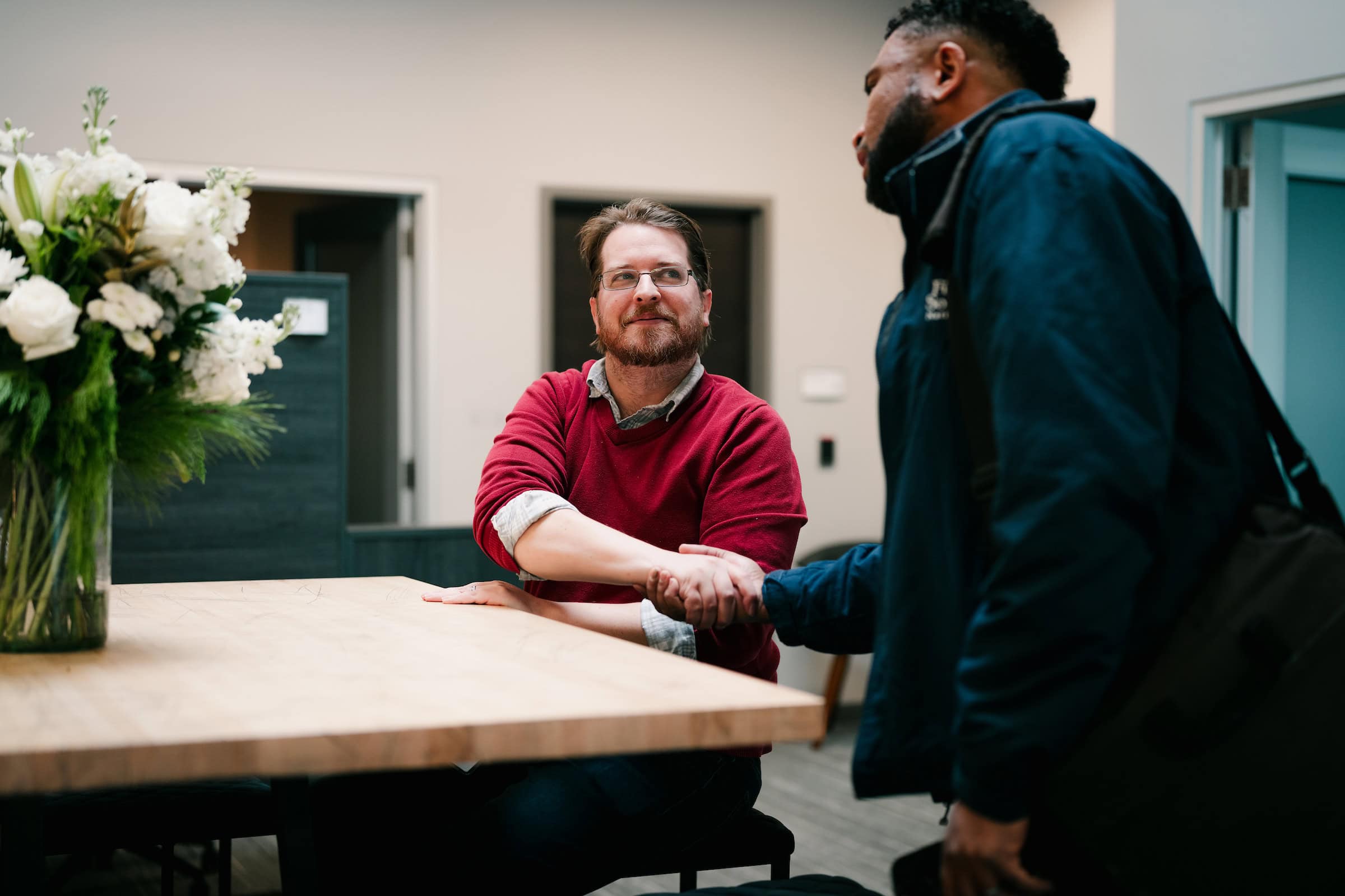 Two men shaking hands in a bank office