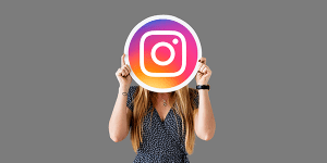 Bright woman holding Instagram logo for KK Catering social media marketing.