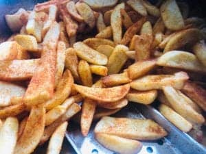 Crunchy seasoned potato wedges ready for catering or snack catering services.