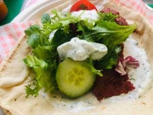 Fresh Mediterranean salad on flatbread from KK Catering, perfect for catering services.