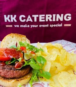 Fresh homemade burger with crispy chips and salad at KK Catering event.
