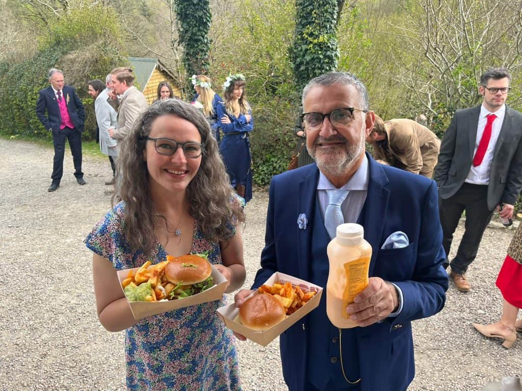 Delicious wedding catering with burgers and fries provided by KK Catering at an outdoor event.