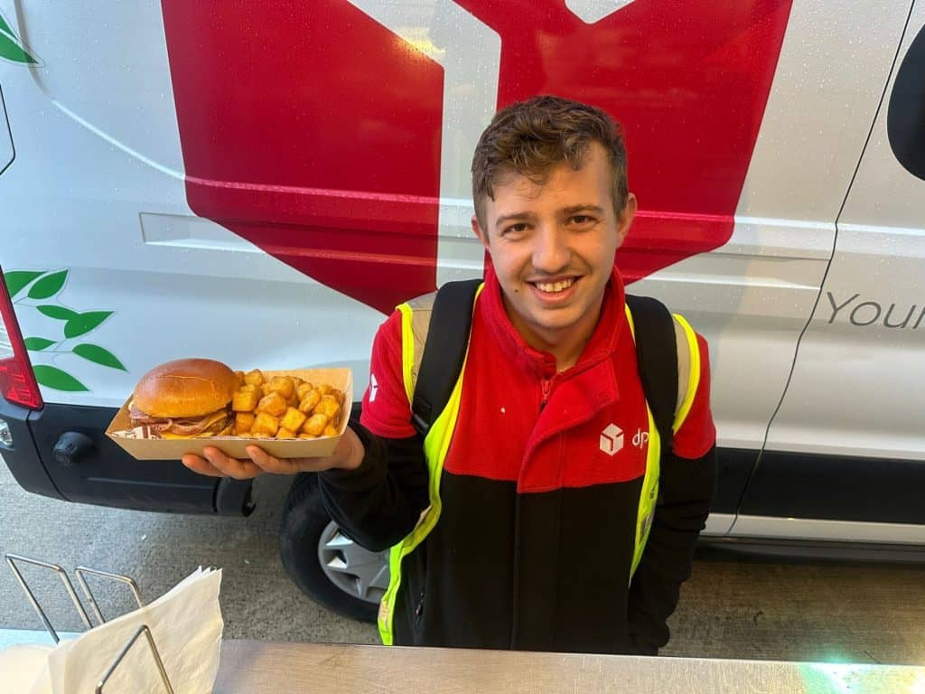 Golden crispy fries and a beef burger served at KK Catering in the UK.