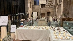 Elegant catering event with desserts and floral arrangements at a historic venue.