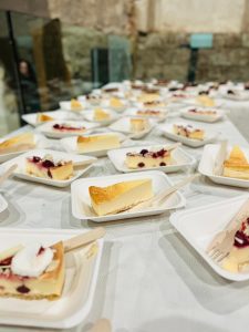 Delicious cheesecake slices with berries served at KK Catering event in a rustic venue.