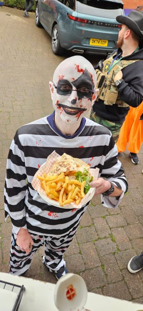 Blood splatter face paint horror costume for events.