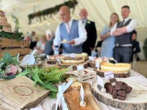 Delicious dessert table at a wedding reception with a variety of cakes, brownies, and sweet treats.