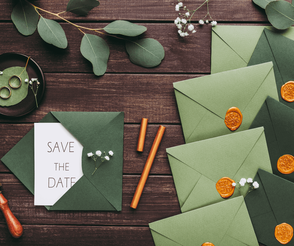 Elegant wedding invitations with green envelopes and wax seals for bespoke event stationery.