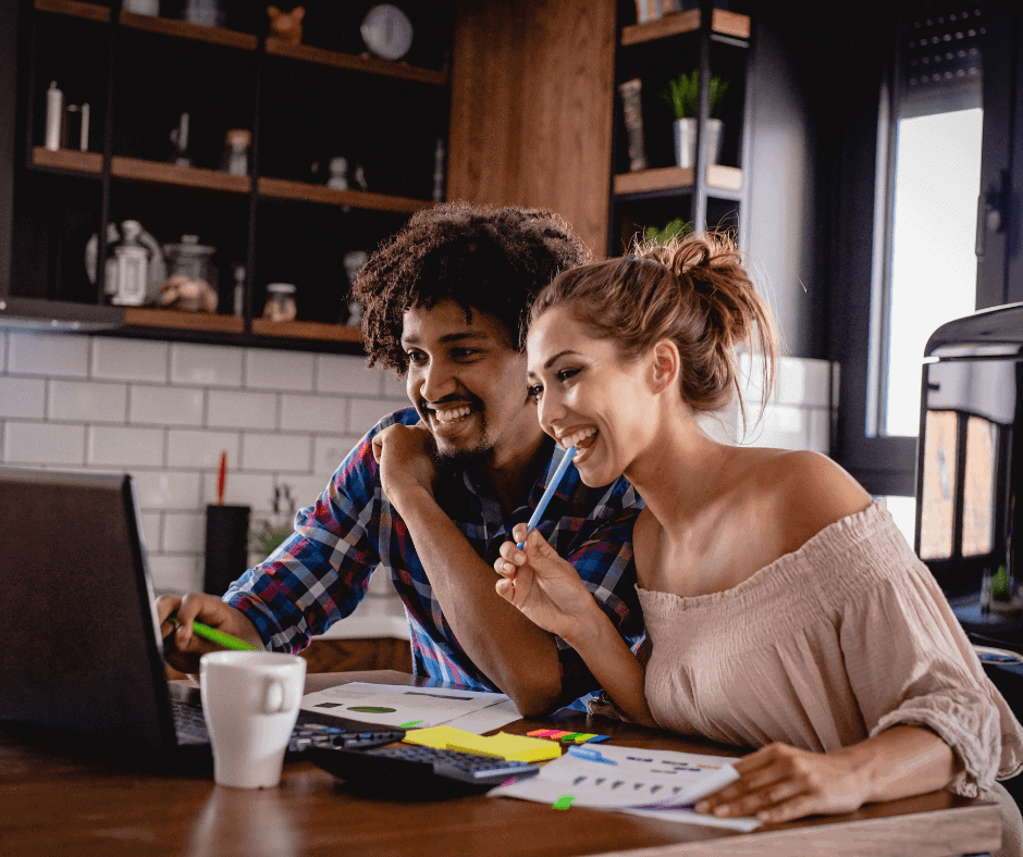 Diverse colleagues enjoying a virtual meeting with catered food from KK Catering in a modern kitchen.