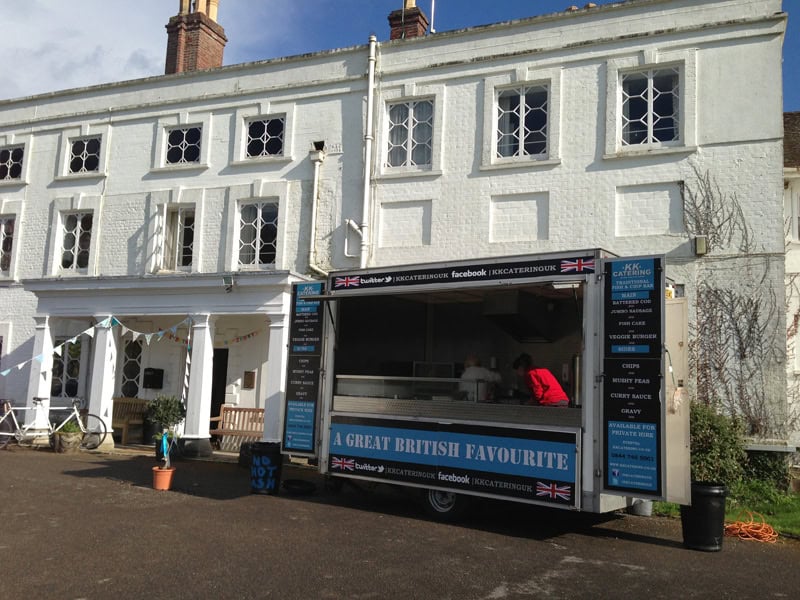 Mobile fish and chips food van at a UK seaside town, offering traditional British takeaway.