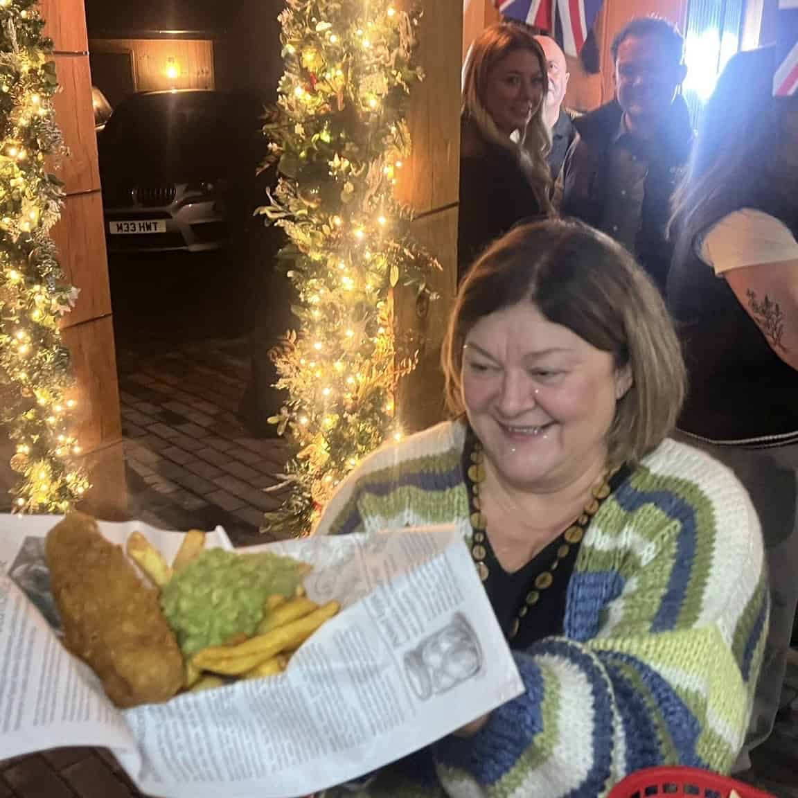 Fish and chips served at a festive event, highlighting traditional British cuisine.