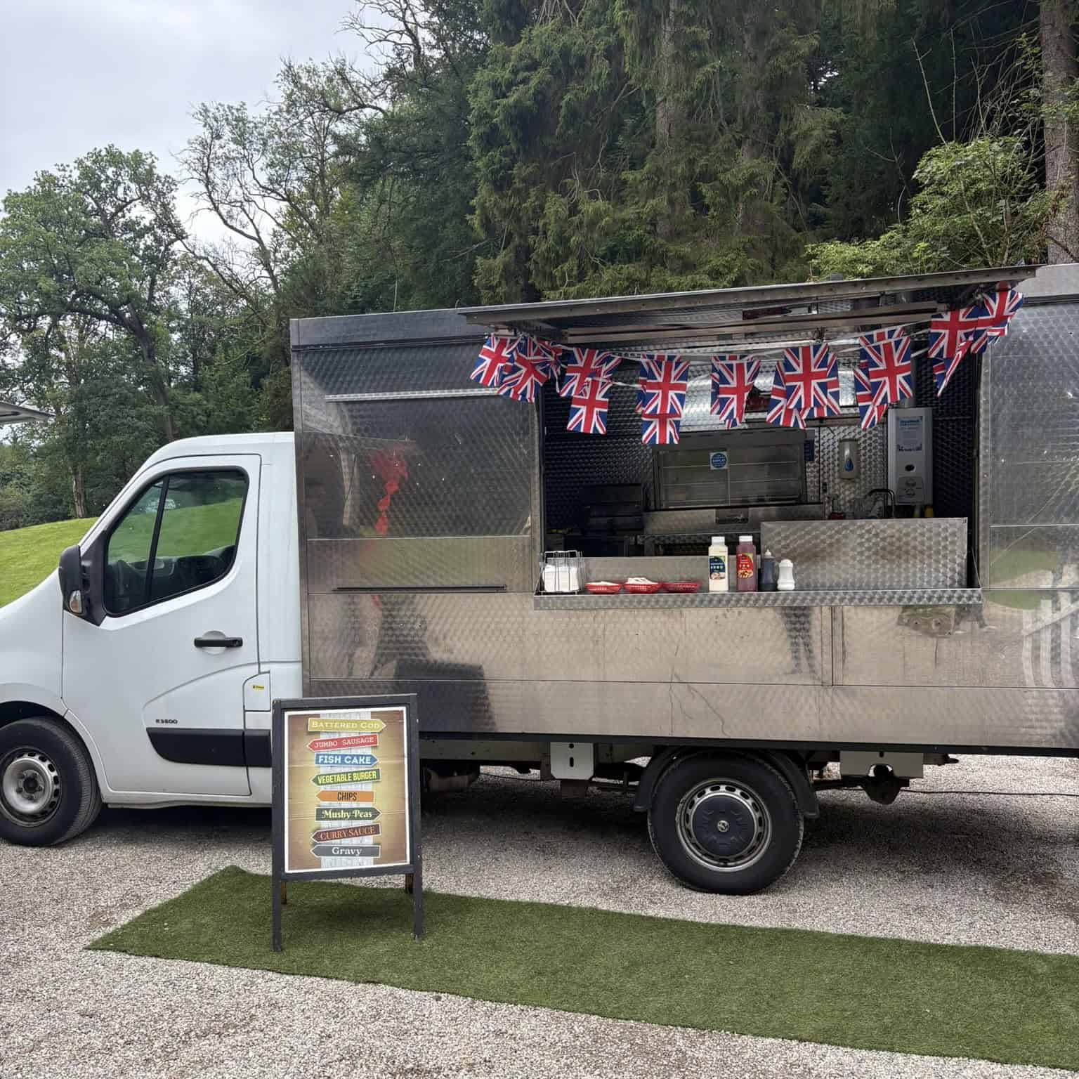 Mobile catering food truck serving British-style cuisine with Union Jack decoration.