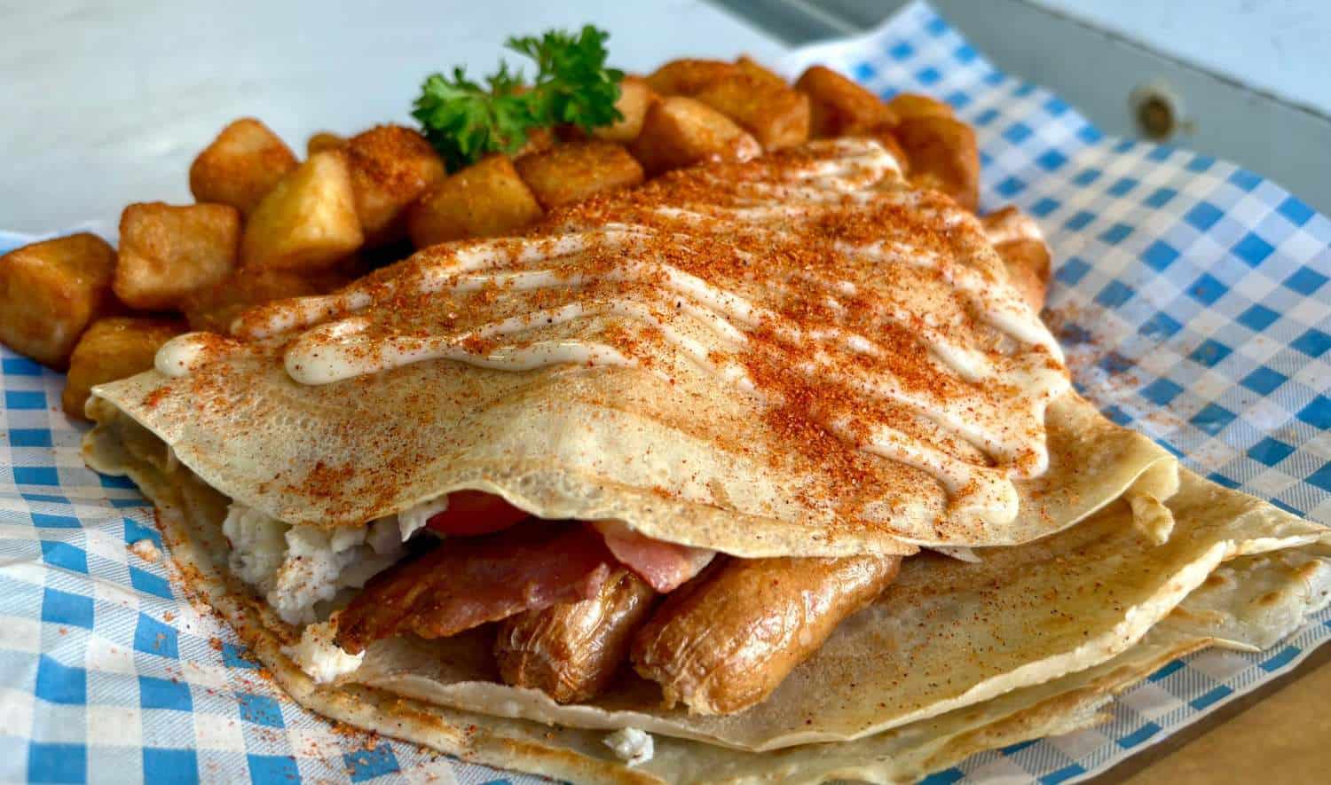 breakfast crepe with bacon egg sausage and scrambled egg