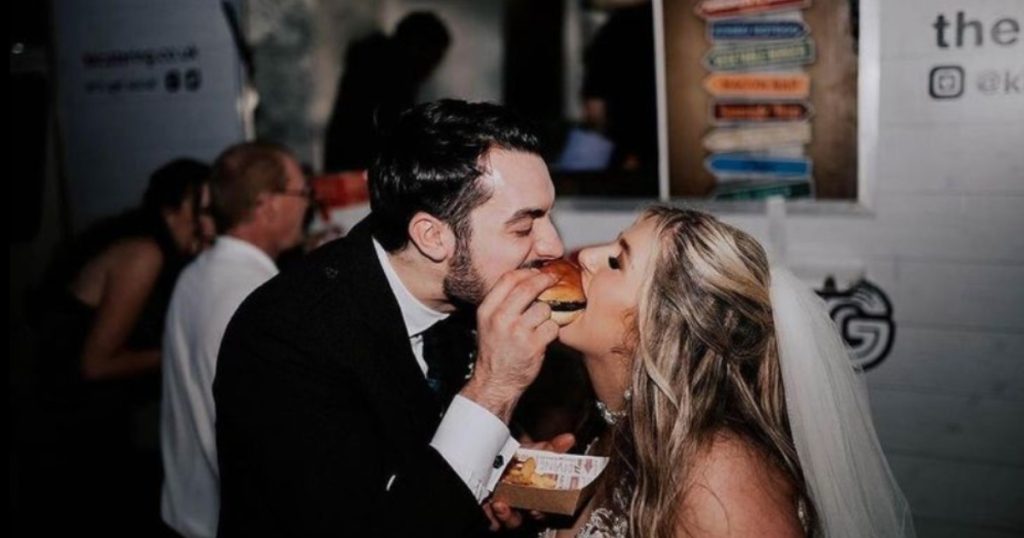 bride and groom eating burgers