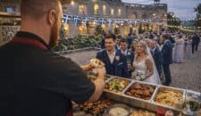 kk catering chef serving wedding guests from the greek street food menu