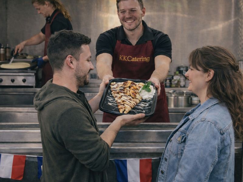 Freshly prepared chocolate and banana crepe served by KK Catering to happy customers at a community event.
