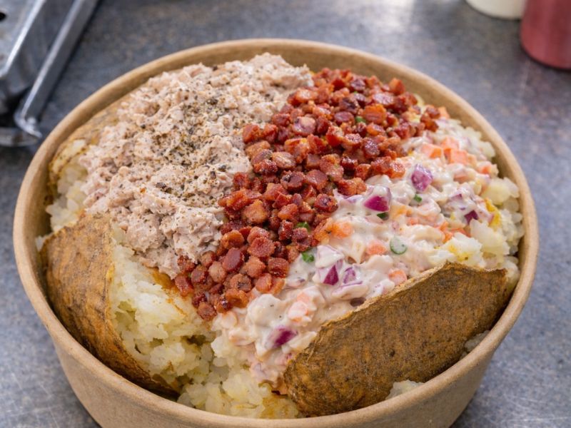 Neptune's Treasure gourmet baked potato — line-caught tuna and creamy coleslaw.