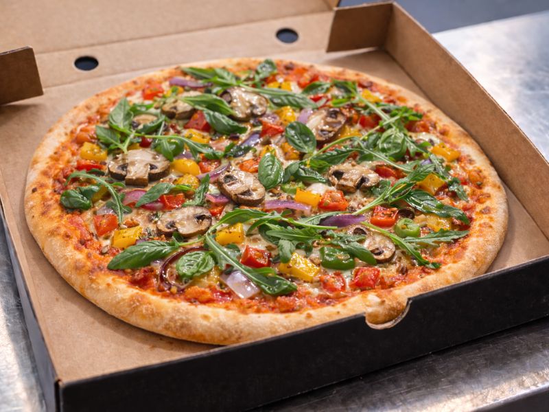 The Veggin' Out pizza with peppers, mushrooms, red onion, basil and olive oil from KK Catering pizza van hire.