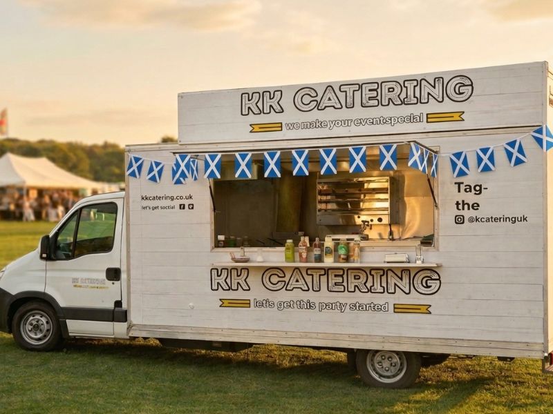 KK Catering fish and chip van with open serving hatch at a Glasgow outdoor evening event, Saltire bunting and golden sunset sky