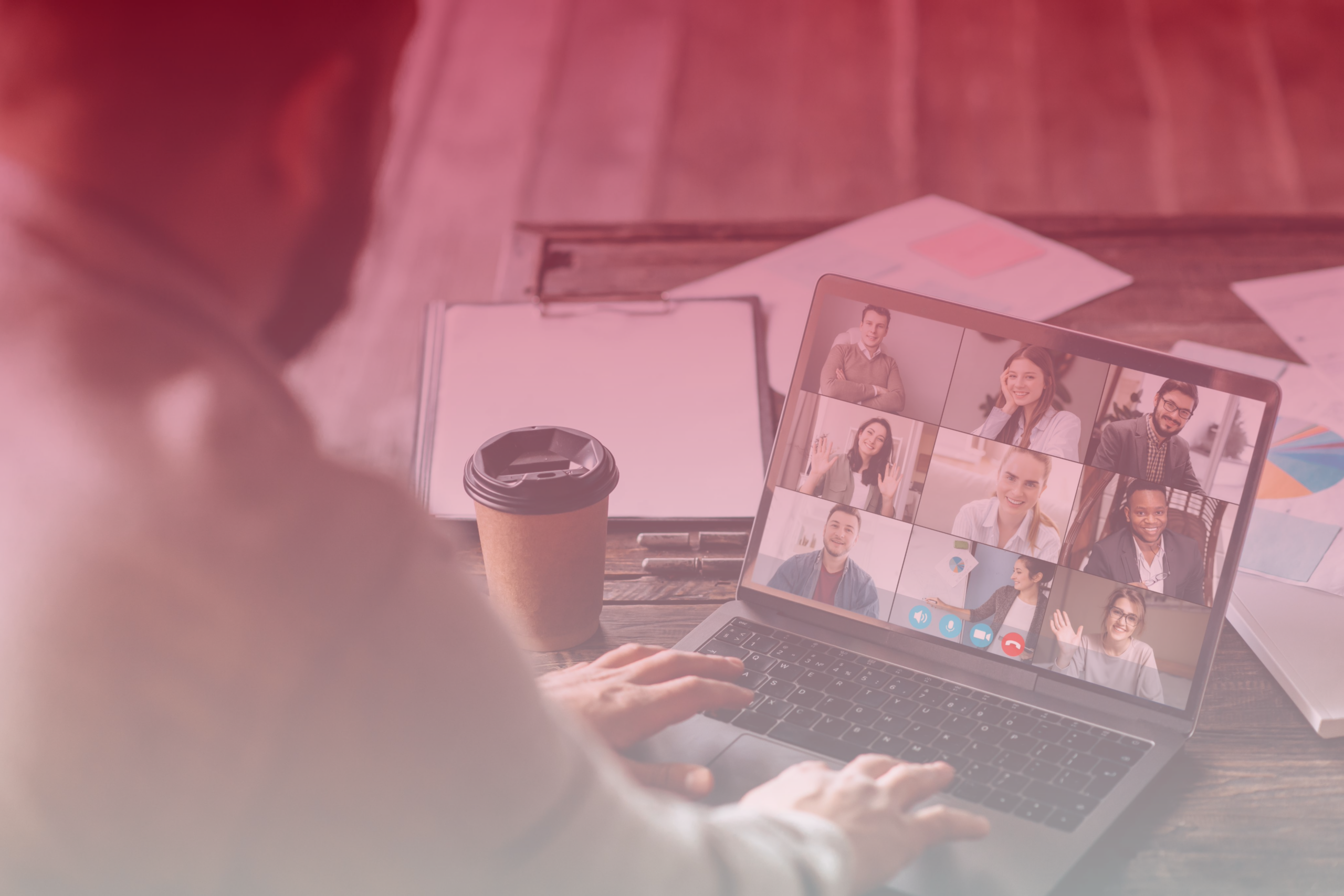 Person attending a virtual meeting with participants visible on the laptop.