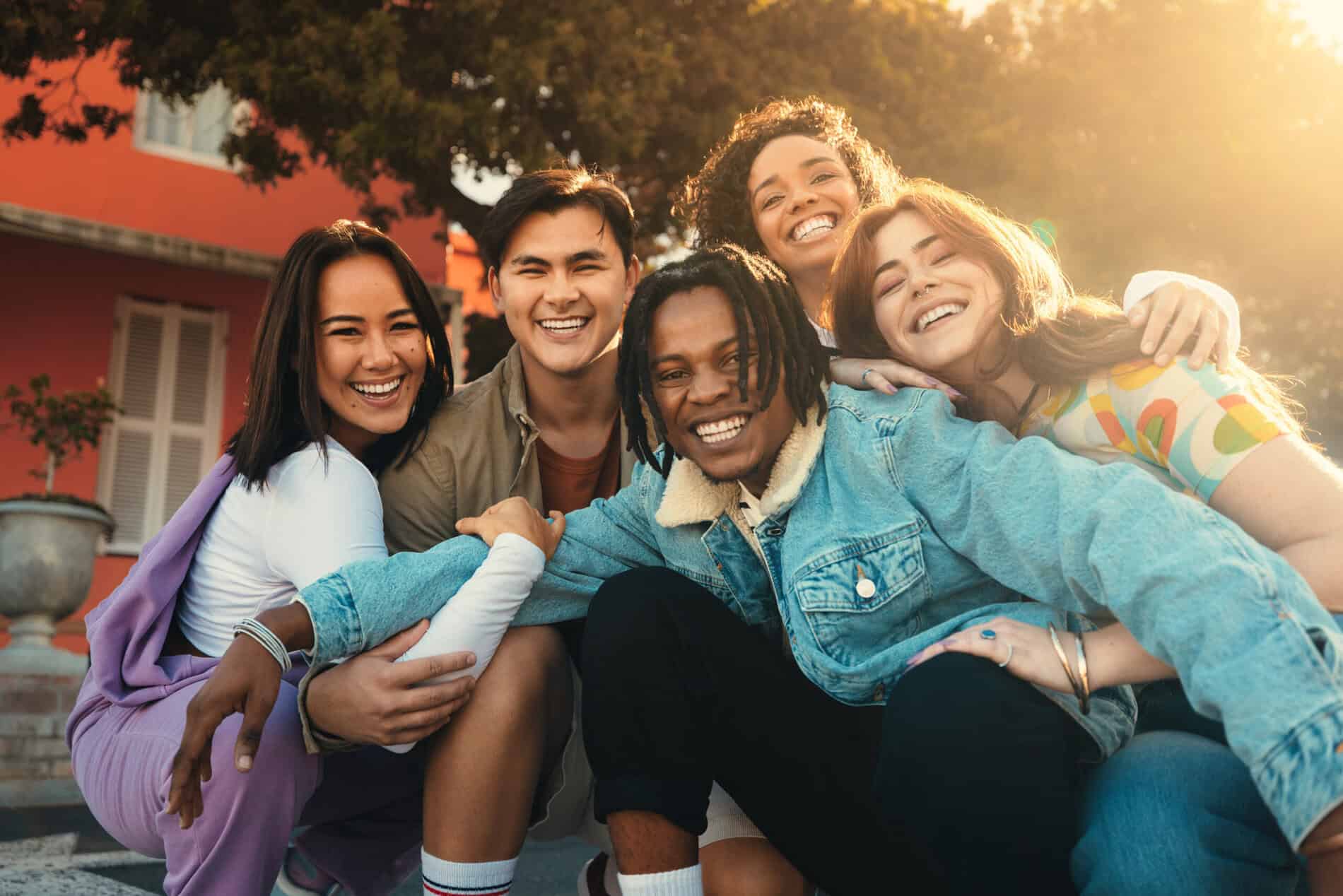 Group of happy friends smiling and bonding while participating in a study abroad program outdoors.