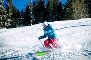 A woman is skiing in the mountains
