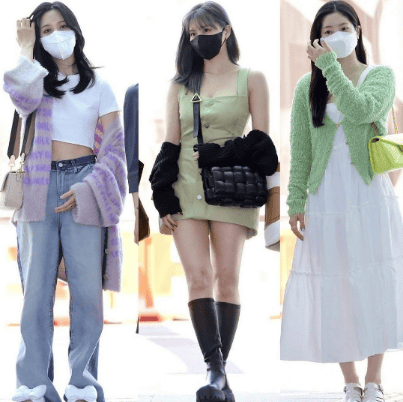 K-Pop idol walking through airport in stylish streetwear.