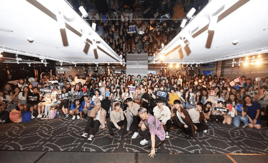 International fans gathered for a K-Pop fan event with banners and posters.
