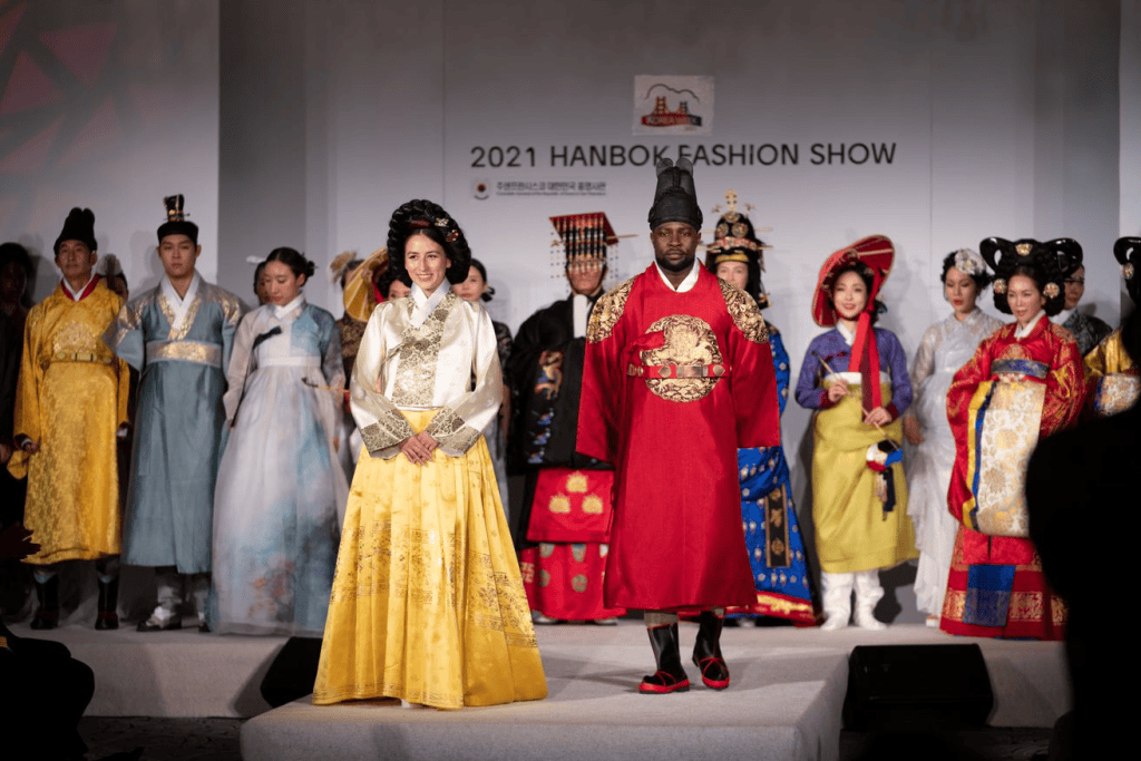 Models wearing modern hanbok-inspired outfits on a runway.