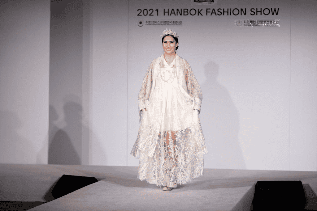 Models wearing modern hanbok-inspired outfits on a runway.
