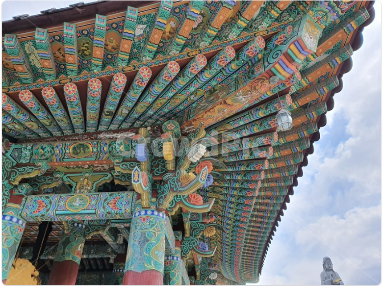 Close-up of colorful dancheong patterns on a Korean temple roof.