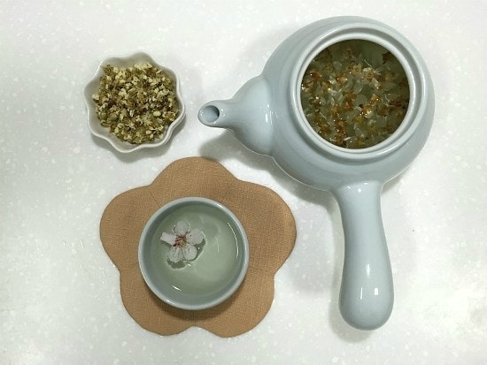 A traditional Korean tea cup with steaming hot tea.