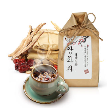 Korean tea with ginseng and herbal ingredients on a wooden table.