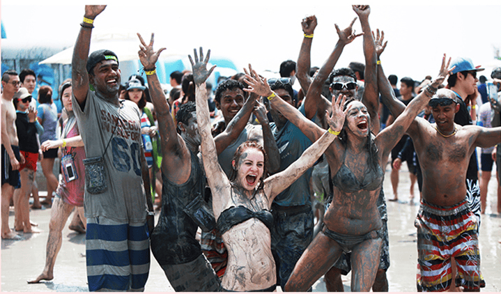 Tourists covered in mud enjoying the Boryeong Mud Festival.