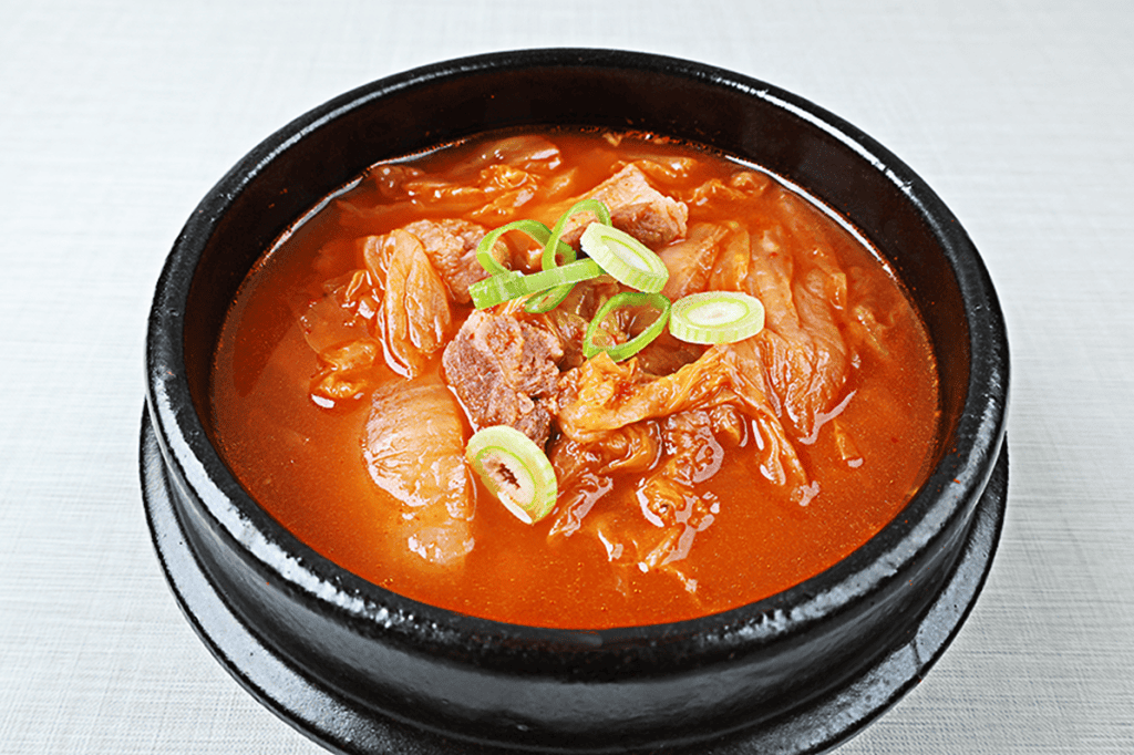 A hot pot of Korean kimchi stew with pork and tofu.