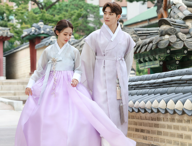 Korean man and woman wearing traditional hanbok outfits