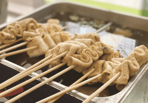 Korean fish cake skewers simmering in broth.
