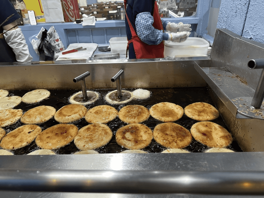 A sweet Korean hotteok pancake filled with brown sugar and nuts.