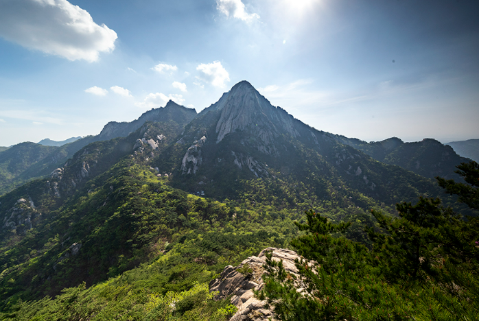 View of Bukhansan Mountain with fortress walls and forested trails.