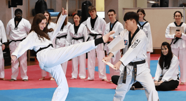 Korean students practicing Taekwondo in uniform.