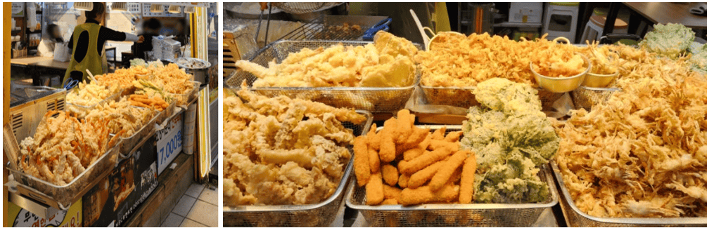 A plate of assorted Korean fried snacks including vegetables and shrimp.