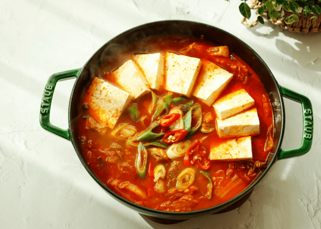Close-up of kimchi stew boiling in traditional Korean pot