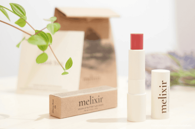 Melixir vegan lip butter tubes on wooden background