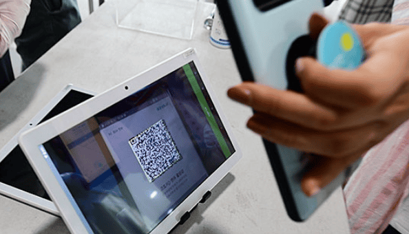 taff scanning concert QR tickets at K-pop venue entrance