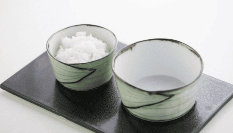 A bowl of freshly steamed Korean white rice in a metal bowl