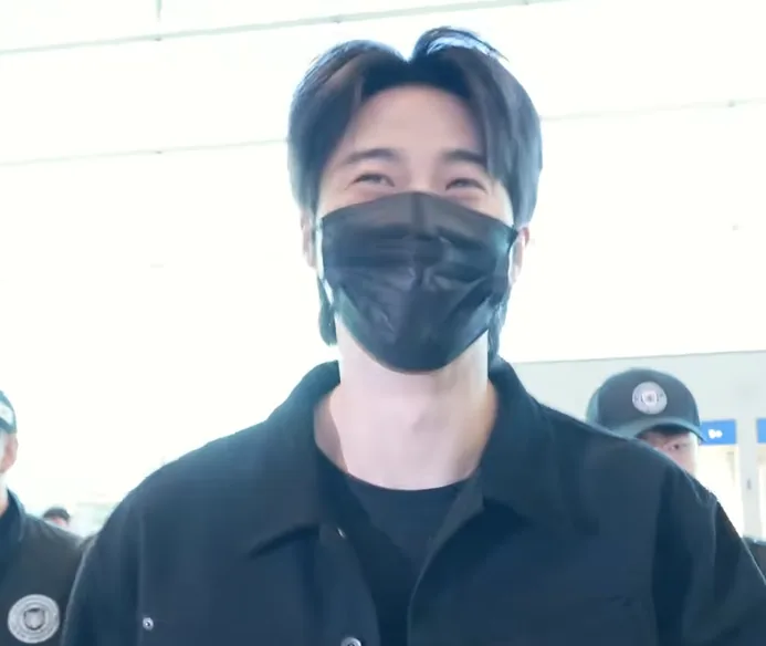 Byeon Woo-seok smiling with his eyes above a black mask