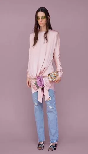 Model wearing the pink Valentino piece with blue jeans