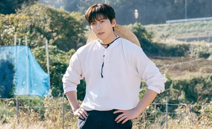 Ji Chang-wook standing outdoors in a white shirt in a scene image